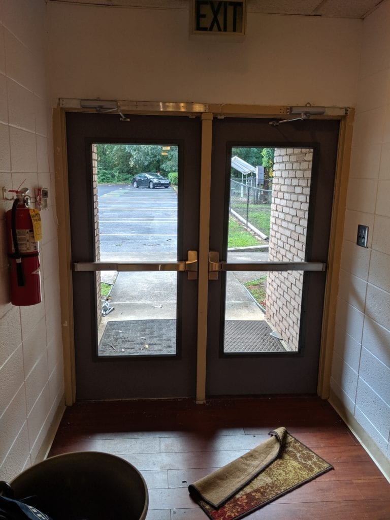 two hollow metal doors installed with full glass and panic hardware